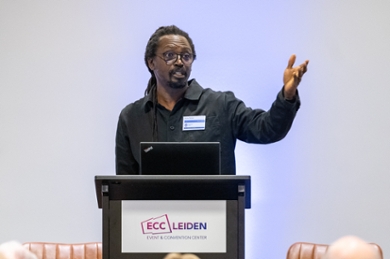 Wayne Modest onstage at the D&I Symposium