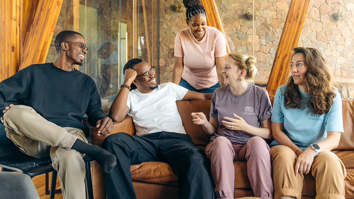 Emily Strange sitting talking with filmmakers and ecologists in Tanzania
