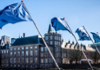 A row of NATO flags flying next to the Hofvijver in The Hague.
