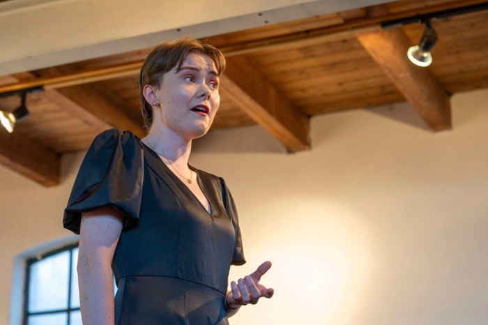 Aimee sings at the top of her voice as she looks out into the concert room.